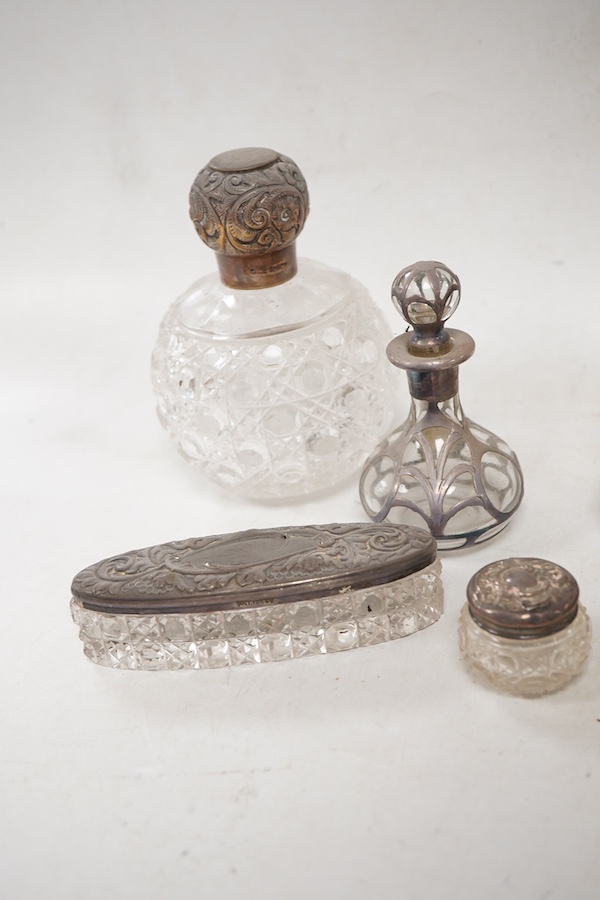 A pair of late Victorian silver mounted cut glass globular scent bottles, by C.C. May & Sons, Birmingham, 1898, height 11.8cm, together with three other silver mounted glass toilet jars and a pair of white metal overlaid
